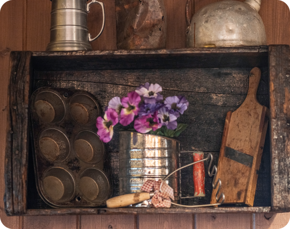 Rustic cookware hanging on a wall.